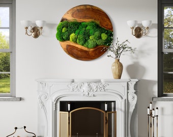 May include: A round wooden wall art piece with a green moss design. The moss is arranged in a flowing pattern, resembling a river or stream. The wood is a rich brown color, and the moss is a vibrant green.