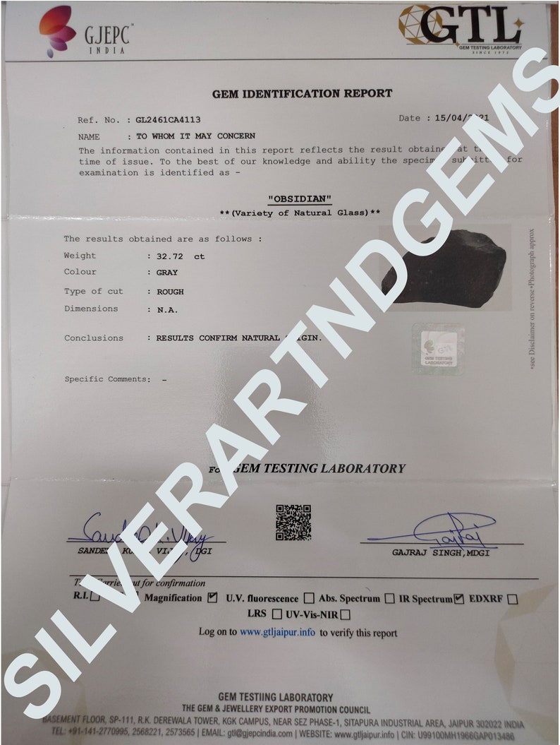 May include: A GTL Gem Identification Report for a 32.72 ct rough grey obsidian specimen. The document includes the GJEPC India logo, reference number GL2461CA4113, dated 15/04/2021, and features two signatures at the bottom with a QR code.