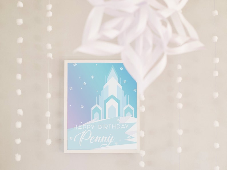 May include: A white framed print with a blue and purple gradient background. The print features a silhouette of an ice castle and the text "Happy Birthday Penny".
