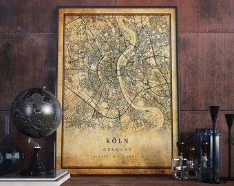 May include: Vintage style map print of Cologne, Germany. The map is in black and white with a beige background. The text "KÖLN GERMANY 50.9375° N | 6.9603° E" is printed at the bottom of the map.