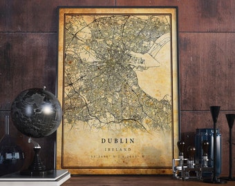 May include: A vintage-style map print of Dublin, Ireland, in a black frame. The map is beige with brown and black lines and text. The text at the bottom reads "DUBLIN, IRELAND, 53.3498° N | 6.2603° W".