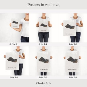 May include: Six different sizes of posters featuring a map of El Salvador with a grey and brown colour scheme. The posters are held by people in the image. The sizes are 8.5x11, 11x14, 16x20, 18x24, 20x30, and 24x36 inches.