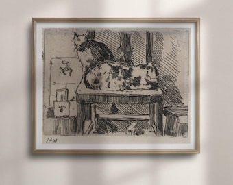 May include: A framed black and white ink drawing on paper depicting two cats resting on a wooden table. One cat sits upright while the other lies down. A small symbol resembling a triskelion is visible on the wall behind the table.