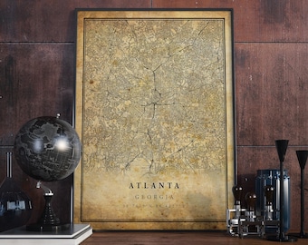 May include: A vintage-style map print of Atlanta, Georgia. The map is in black and white with a faded, aged look. The text "Atlanta, Georgia 33.7490° N 84.3877° W" is printed at the bottom of the map.