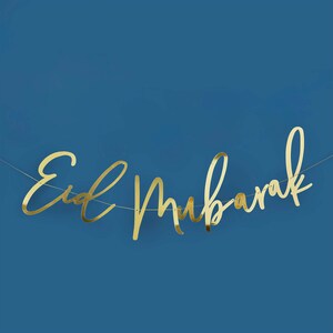 May include: Gold foil banner with the text "Eid Mubarak" on a blue background.