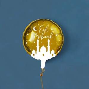May include: A gold foil balloon with the text "Eid Mubarak" and a white silhouette of a mosque.