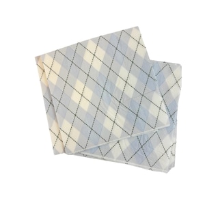 May include: A stack of white and blue patterned paper napkins with a black diamond pattern.