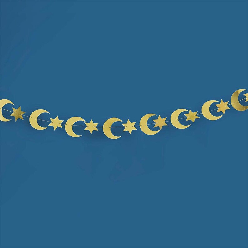May include: A gold garland with alternating crescent moons and stars. The garland is perfect for decorating for Ramadan or Eid.