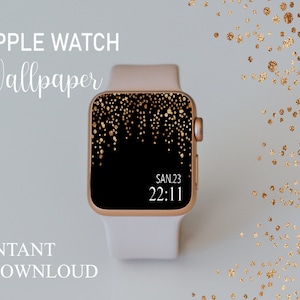 Può includere: Un Apple Watch bianco con cinturino dorato e quadrante nero. Il quadrante dell'orologio presenta un design con glitter dorati e mostra la data e l'ora: SAN.23 22:11.