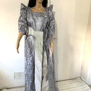 modern gomesi dress Gold on green. This beautiful gomesi and with kitambala and readily available for hire. For these and more, visit us at Equatorial Mall, Level 2, Shop M7 or contact us on 0700514121. #