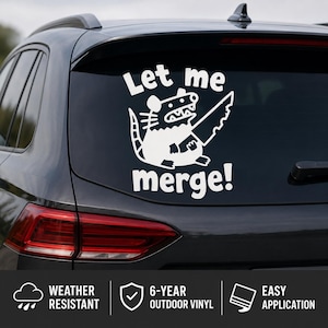 May include: A white vinyl decal applied to a car rear window featuring a cartoon opossum holding a large serrated knife. The text above the opossum reads Let me and the text below the opossum reads merge! in a bold, rounded white font style.