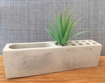 Concrete desk organiser tidy with artificial plant