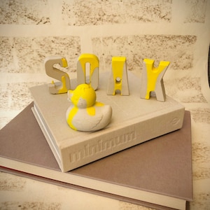 Yellow drip Concrete ‘rubber’ duck with ‘SOAK’ letters