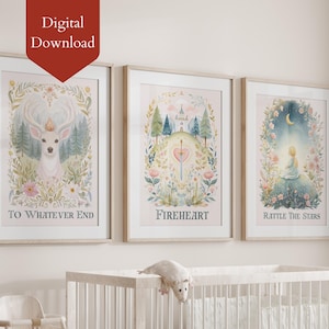 May include: Three framed watercolour art prints with light wood frames. The prints feature whimsical illustrations of a deer, a heart and sword, and a figure under a crescent moon. Text on the prints reads "TO WHATEVER END", "FIREHEART", and "RATTLE THE STARS".
