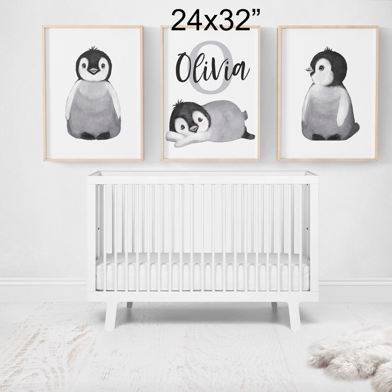 May include: Three framed prints featuring watercolor illustrations of penguins. The middle print has the name "Olivia" written in a decorative font.