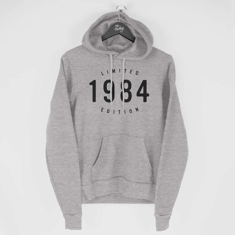 a grey hoodie with the number thirteen on it