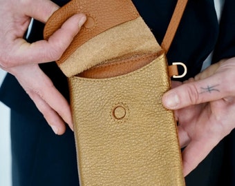 orange leather mobile phone case with money pocket. Slim shoulder bag with magnetic closure. adjustable leather strap. Nice gift idea.