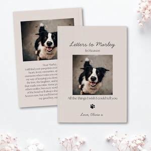 Op de afbeelding: Een lichtbeige herinneringsboek getiteld Letters to Marley In Heaven met een foto van een zwart-witte hond. De kaft bevat de tekst All the things I wish I could tell you, een klein zwart pootafdruk-icoon en de ondertekening Love, Olivia x.