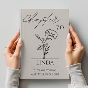 May include: A book cover featuring the words "Chapter 70" in cursive script above a floral illustration. Below the illustration, the name "Linda" is printed, followed by "70 YEARS YOUNG AND STILL FABULOUS."