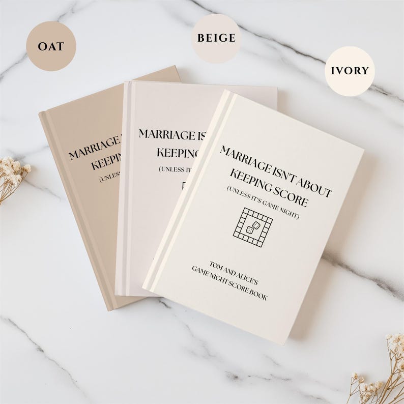 May include: Three score books in oat, beige, and ivory colors. Each book features the black text: MARRIAGE ISN'T ABOUT KEEPING SCORE (UNLESS IT'S GAME NIGHT), a board game icon with dice, and the text TOM AND ALICE'S GAME NIGHT SCORE BOOK.