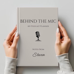 May include: A light gray podcast planner titled "BEHIND THE MIC" with the subtitle "MY PODCAST PLANNER." A black microphone graphic is centered below the title. The name "Steven" is printed below the graphic. The planner is held by two hands.