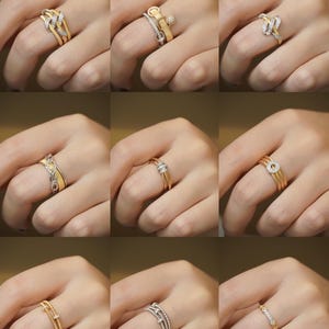 Pu&ograve; includere: Nove anelli diversi in oro e argento con accenti di diamanti. Gli anelli sono mostrati sul dito di un modello.