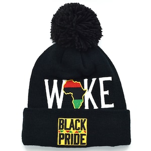 May include: Black beanie with a pom pom on top. The beanie has the word "WOKE" written in white with an outline of the continent of Africa in red, yellow, green, and black. The beanie also has a yellow patch that says "BLACK PRIDE" in black letters.