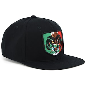 May include: Black baseball cap with a large embroidered patch featuring the Mexican coat of arms. The patch is green, white, and red with a golden eagle perched on a cactus.