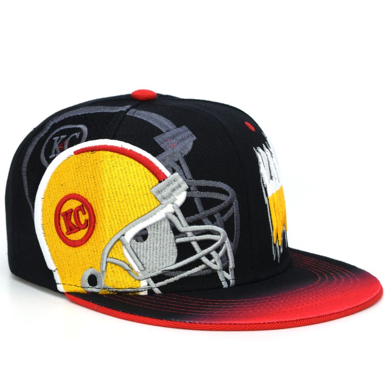 May include: Black and red baseball cap with a yellow and grey football helmet graphic and the letters "KC" embroidered on the front.