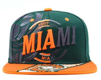 May include: A dark green baseball cap with an orange brim and an orange button on top. The front features the word MIAMI embroidered in orange and dark gray, with the word FOOTBALL above it and a swirling graphic pattern in dark gray and white.