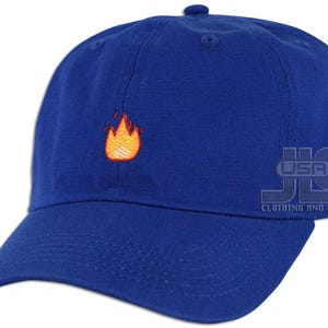 May include: A royal blue baseball cap with an embroidered orange flame design.