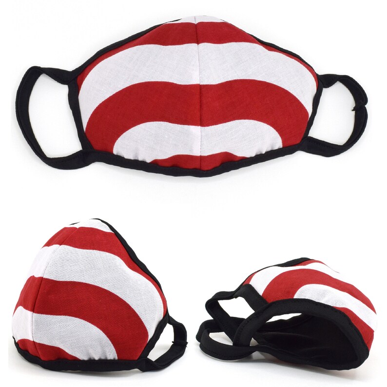 May include: Red and white striped face mask with black elastic ear loops. The mask has a wavy pattern.