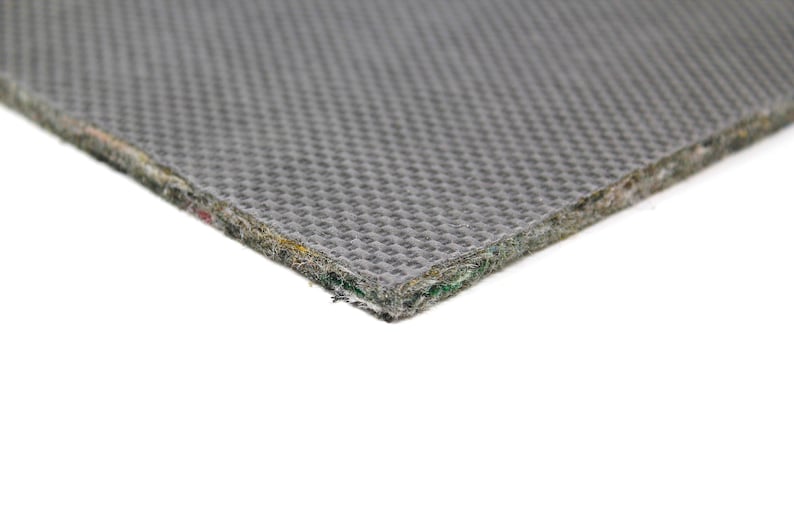 Puede incluir: Primer plano de un material de base gris texturizado. La base est&aacute; hecha de m&uacute;ltiples capas de tela y tiene una textura tejida.