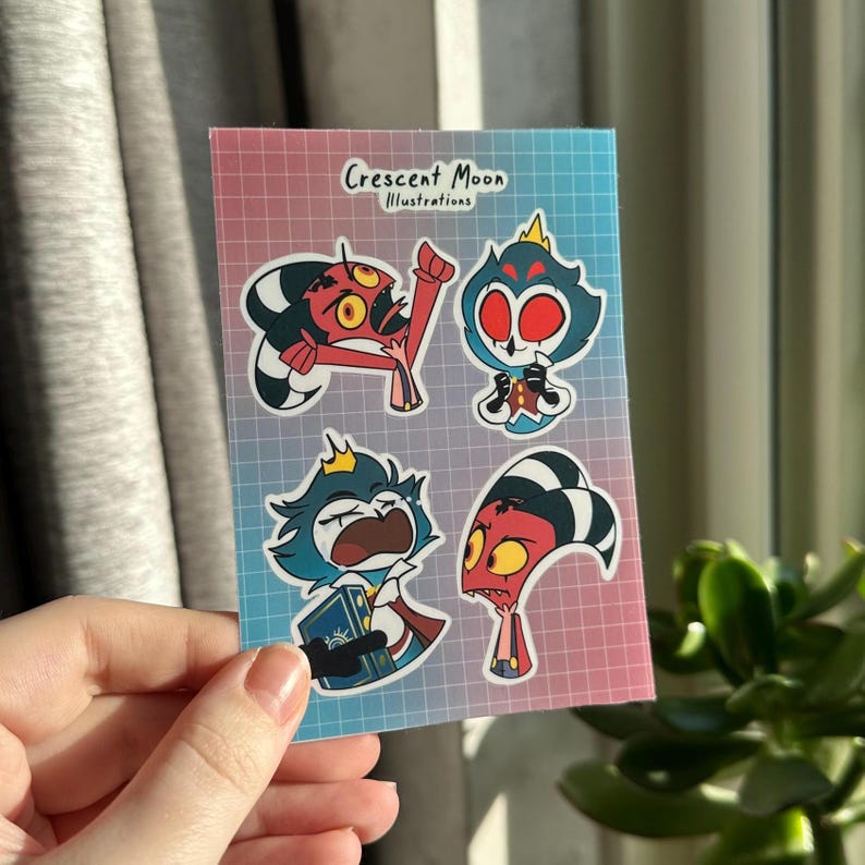 Op de afbeelding: Een set van vier stickers met personages uit de animatieserie "Helluva Boss". De stickers zijn gedrukt op een transparante achtergrond met een rasterpatroon. De personages worden afgebeeld in verschillende poses en uitdrukkingen. De stickers zijn gelabeld met "Crescent Moon Illustrations".
