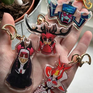 Vox, Lucifer & Alastor Hazbin Hotel Keychain - Perfect for fans! Enchanting design and decorative. Must-have for Hazbin Hotel enthusiast! image 1