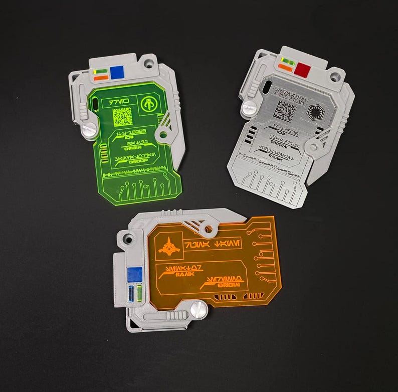 May include: Three plastic key cards with different colored translucent panels. The cards have a circuit board design and text on them. The text on the cards reads "77MC", "SK-470", "3M14K J073K", "7J1AK VK4M1", "3M14K J07", "3M7V140", "ORIGIN", "RANK", "77MC", "SK-470", "3M14K J073K", "ORIGIN", "RANK", "17-4357-30", "0038", "CR3514M", "J14K J14K14", "RANK", "ORIGIN".
