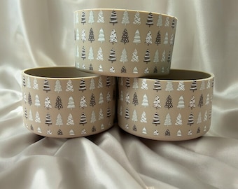 May include: Three beige ceramic bowls with a white and brown Christmas tree pattern.