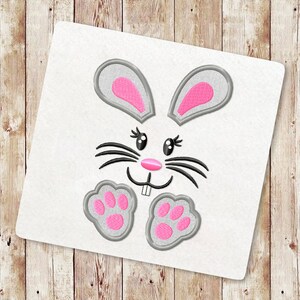 May include: Embroidered design of a gray bunny rabbit with pink ears, nose, and paw prints. The bunny has black whiskers and black eyes.