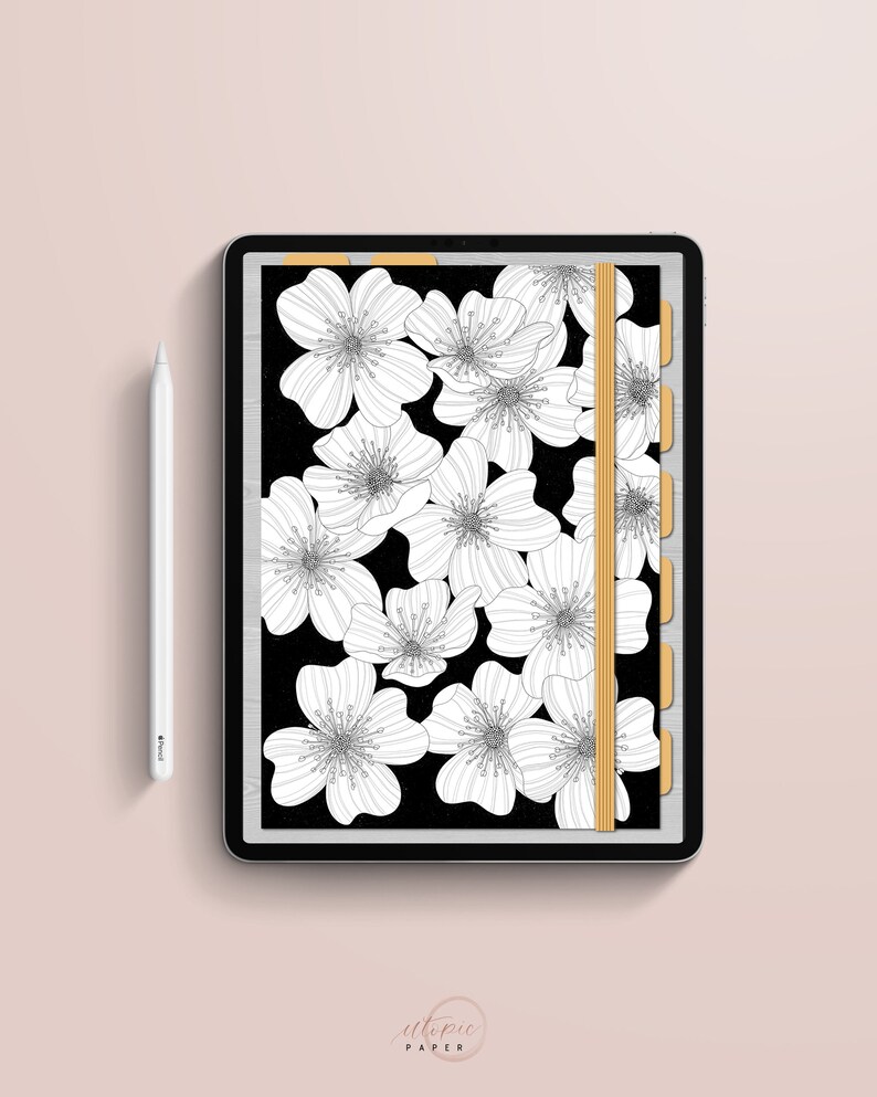 May include: A digital planner on a tablet featuring a black background with white floral illustrations. The planner has a gold elastic band and tabs. A white stylus is positioned to the left. The text "utopic PAPER" is at the bottom.