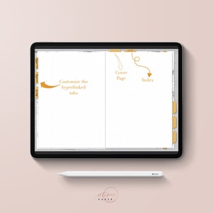 May include: A digital planner displayed on a tablet with a white stylus. The planner has customizable tabs and a cover page. The text on the screen includes "Cover Page" and "Index". The background is a soft pink.