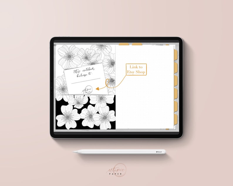 May include: A digital notebook displayed on a tablet, featuring a floral design in black and white. The notebook includes a section for personal information and a link to an Etsy shop. A white stylus rests below the tablet.