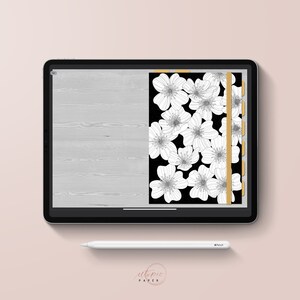 May include: A digital planner displayed on a tablet. The planner features a black background with white floral illustrations. A gold vertical tab and a light gray wood grain design are also visible. A white stylus and the text "utopic PAPER" are present.