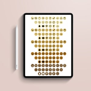 May include: A digital tablet displaying a collection of gold-colored app icons, including social media and educational symbols. A white stylus rests beside the tablet on a light pink surface. The text "utopic PAPER" is in the bottom right corner.