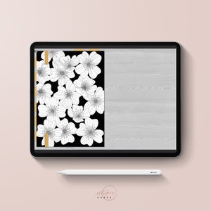 May include: A digital tablet displays a floral design. The design features white flowers on a black background, with a gold border. A white stylus rests below the tablet. The words "utopic paper" are at the bottom.