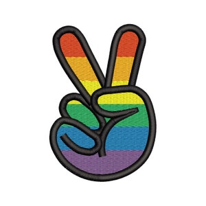 May include: A rainbow peace sign with a black outline. The peace sign is made of fabric and has a textured appearance.