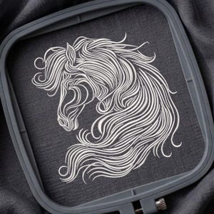 May include: A white embroidered horse head design on a dark gray fabric, held within a gray embroidery hoop. The horse's mane and facial features are detailed with flowing lines. The fabric is taut within the hoop, ready for display or further crafting.