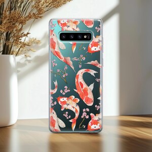May include: A clear phone case with a colorful koi fish pattern. The case has a cutout for the camera lens and is designed for a Samsung Galaxy S10.