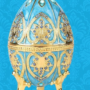 Faberge type egg replica of the lace collection.Swarovski crystals in Caribbean blue egg.This opens up to hold a jewelry box 4.2 tall