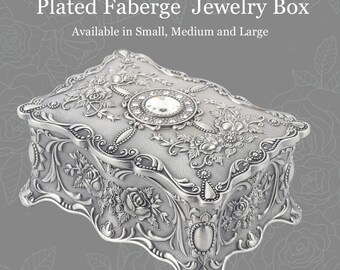 Faberge type jewelry box in a large size. It is a silver color with big Swarovski crystals. It is one of our best sellers. 2 levels 7x5x2.5”