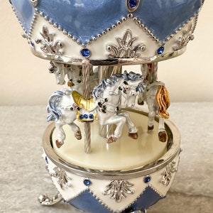 Blue Faberge type egg music box carousel merry go round. This is handmade and play’s springtime. For gift baby gift 6”tall or home decor